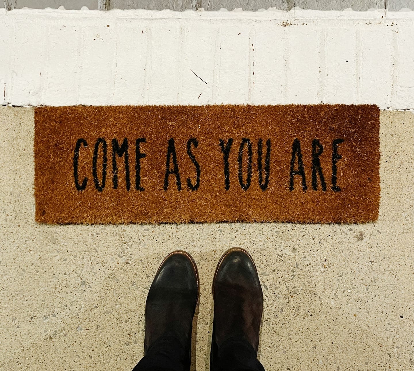 Come as you are.  Shoes on a welcome mat.  Welcoming.